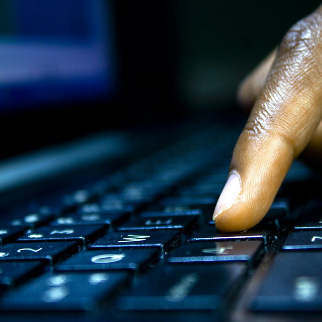 a close up of a person typing on a laptop