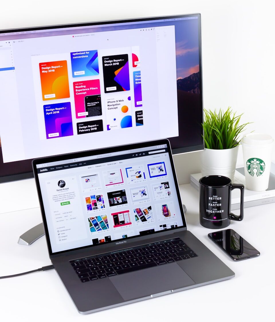 black and gray laptop computer beside black mug