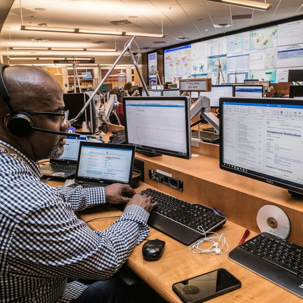 man in black and white checkered dress shirt using computer